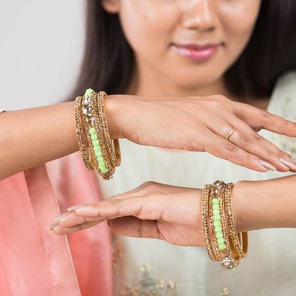 Metal with Zircon Gemstones Glossy Finished Gold & Green Color Bangles Set together in two hands